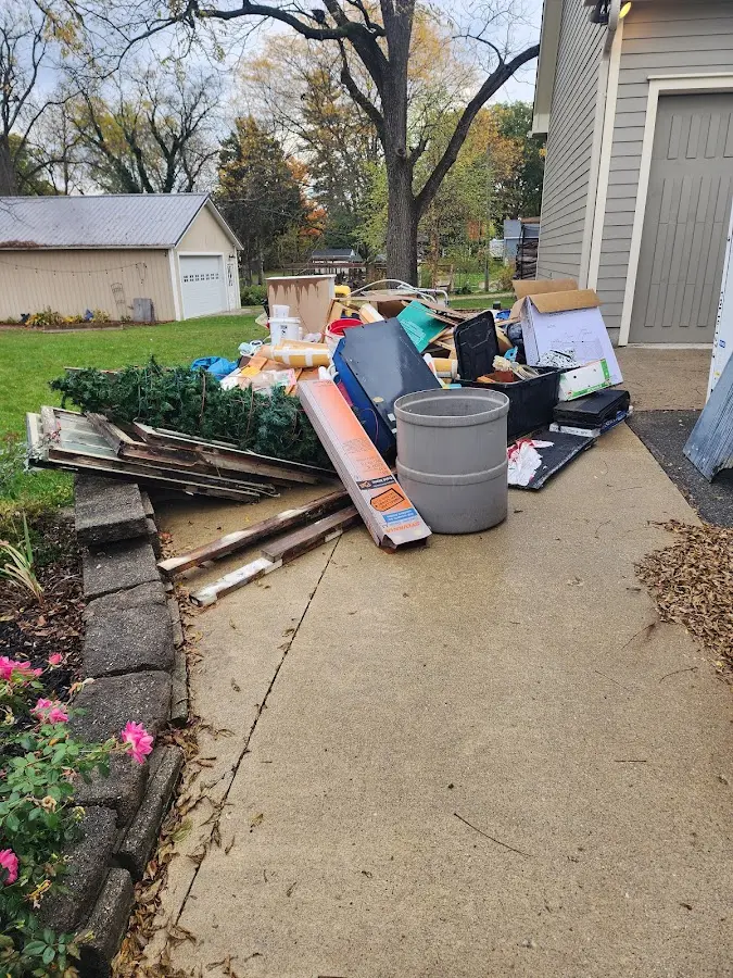 Dumpster being loaded with debris for Roofing Dumpster Rental in Westwood